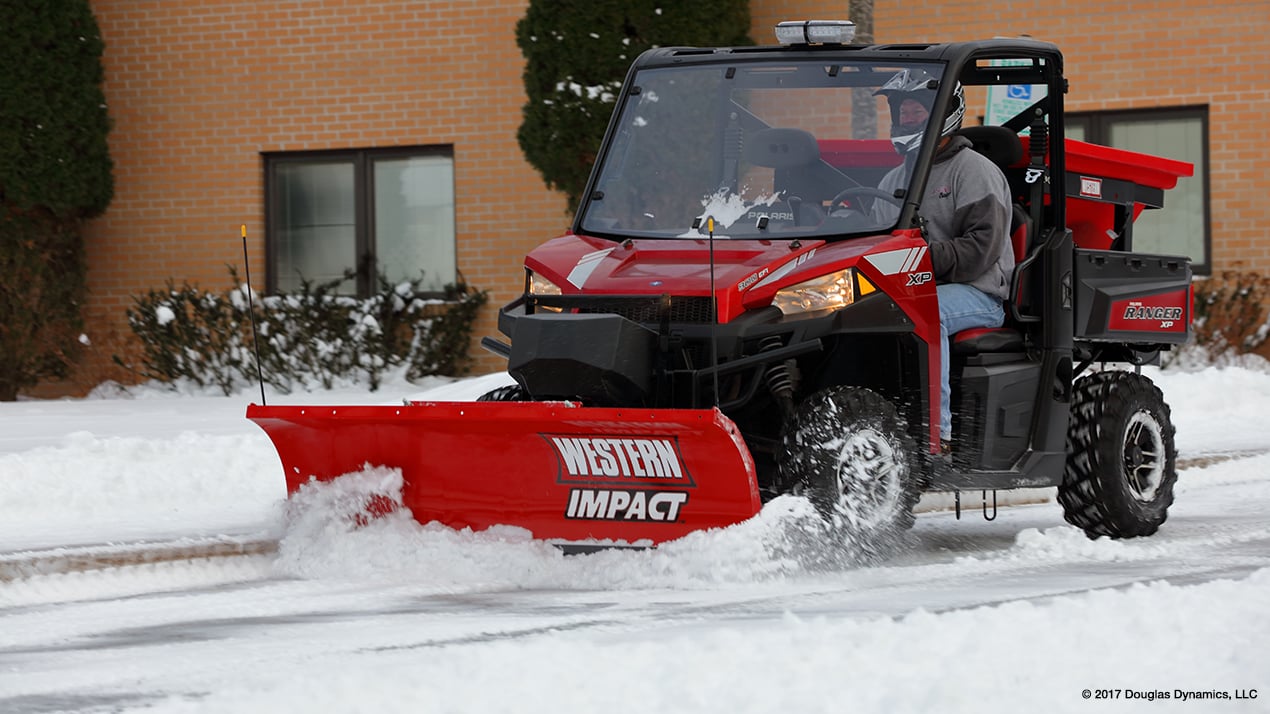 UTV with a Western IMPACT Snow Plow attached