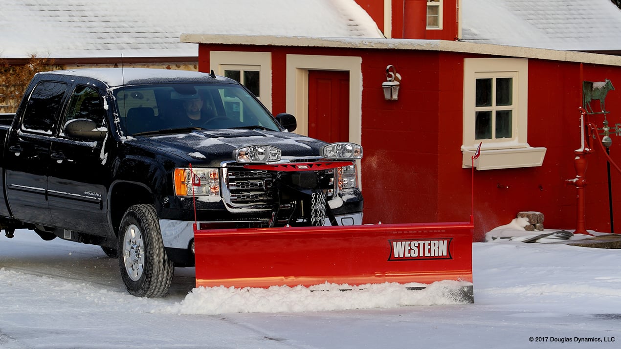 Side profile of a black truck with a Western MIDWEIGHT Snow Plow attached