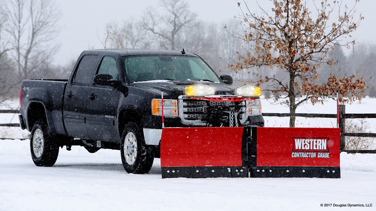 Side profile of a black truck with a Western MVP PLUS Snow Plow attached