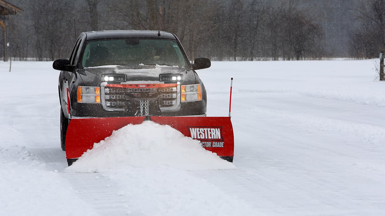 Front profile of a black truck with a Western MVP PLUS Snow Plow attached
